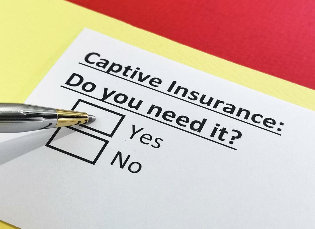 Discover the Power of Captive Insurance - Close-up of a Pen Writing on a Form